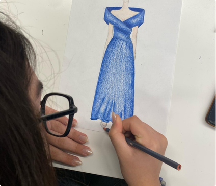 Student developing a fashion design during a creative vocational workshop